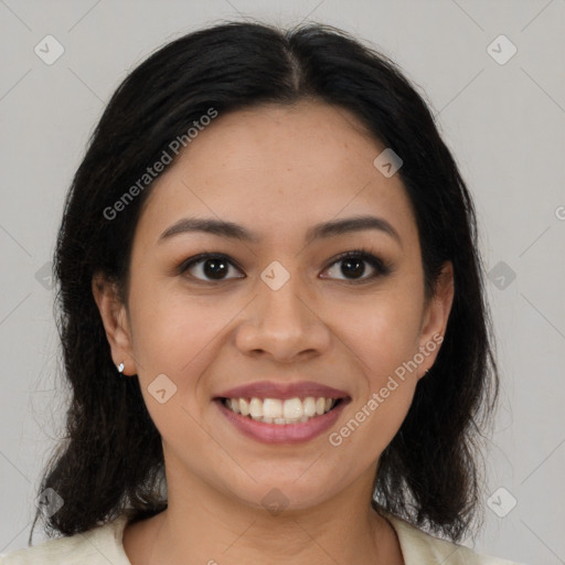 Joyful latino young-adult female with medium  brown hair and brown eyes