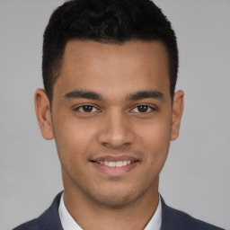 Joyful latino young-adult male with short  black hair and brown eyes