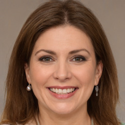 Joyful white young-adult female with medium  brown hair and grey eyes