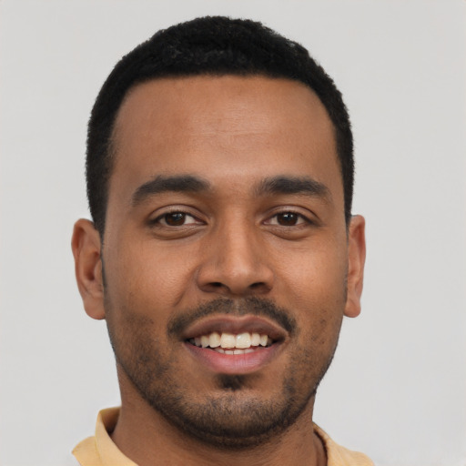 Joyful latino young-adult male with short  black hair and brown eyes