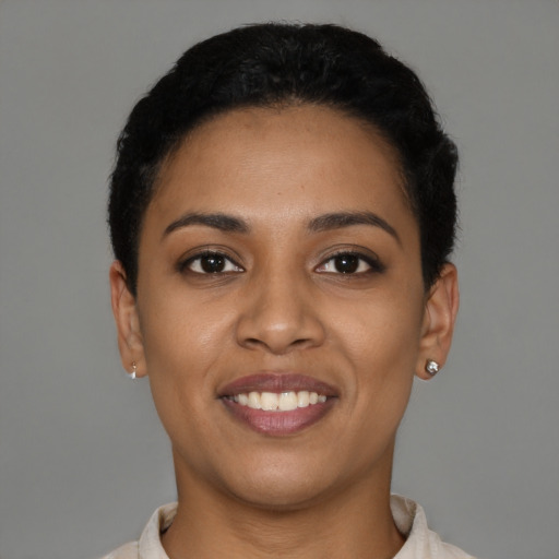Joyful latino young-adult female with short  black hair and brown eyes