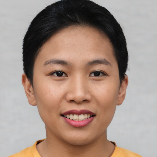 Joyful asian young-adult female with short  brown hair and brown eyes