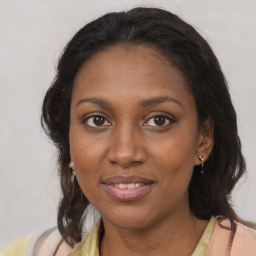 Joyful black young-adult female with medium  brown hair and brown eyes