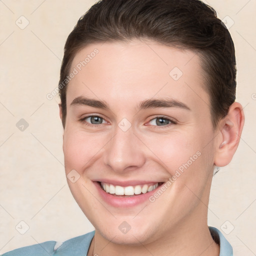 Joyful white young-adult female with short  brown hair and brown eyes