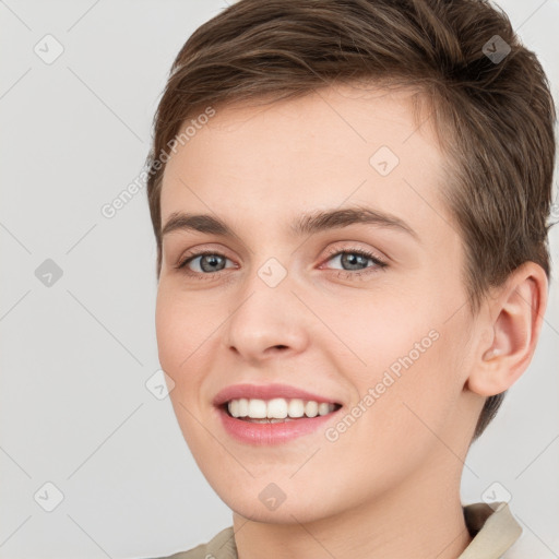 Joyful white young-adult female with short  brown hair and grey eyes