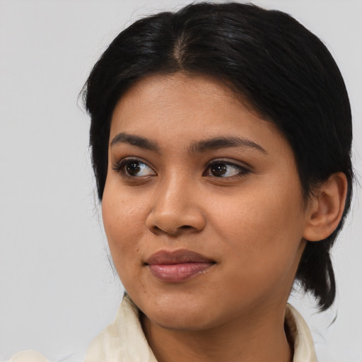 Joyful asian young-adult female with medium  black hair and brown eyes