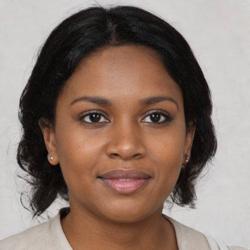 Joyful black young-adult female with medium  black hair and brown eyes
