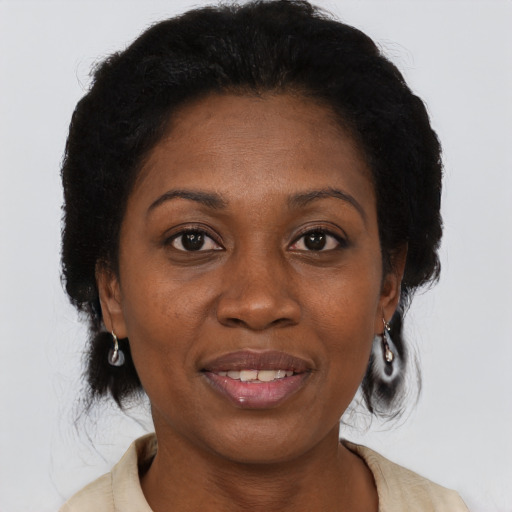 Joyful black adult female with medium  brown hair and brown eyes