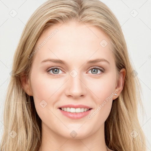 Joyful white young-adult female with long  brown hair and blue eyes