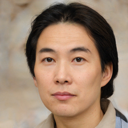 Neutral asian adult male with medium  brown hair and brown eyes