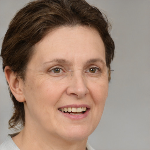 Joyful white adult female with medium  brown hair and grey eyes