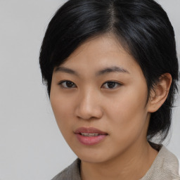 Joyful asian young-adult female with medium  black hair and brown eyes