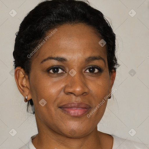 Joyful black adult female with medium  brown hair and brown eyes