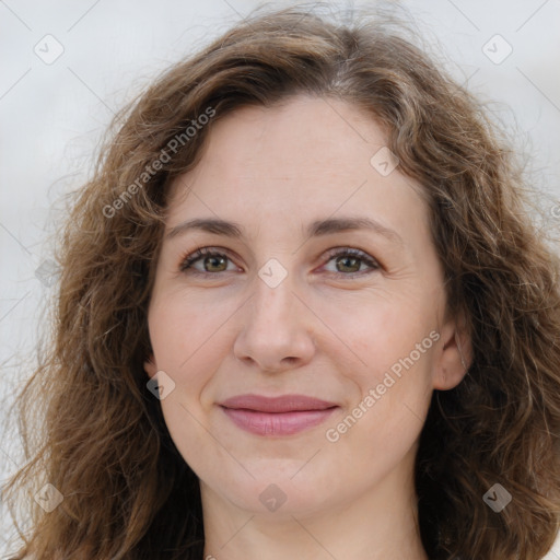 Joyful white adult female with long  brown hair and brown eyes