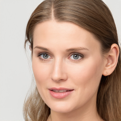 Joyful white young-adult female with long  brown hair and grey eyes