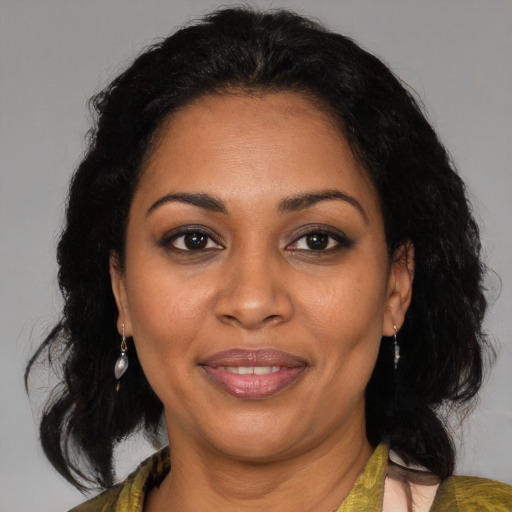 Joyful black adult female with medium  brown hair and brown eyes