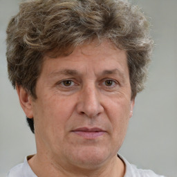 Joyful white middle-aged male with short  brown hair and brown eyes