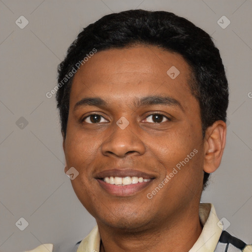 Joyful black young-adult male with short  black hair and brown eyes