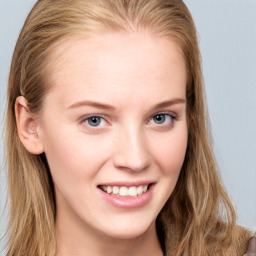 Joyful white young-adult female with long  brown hair and blue eyes