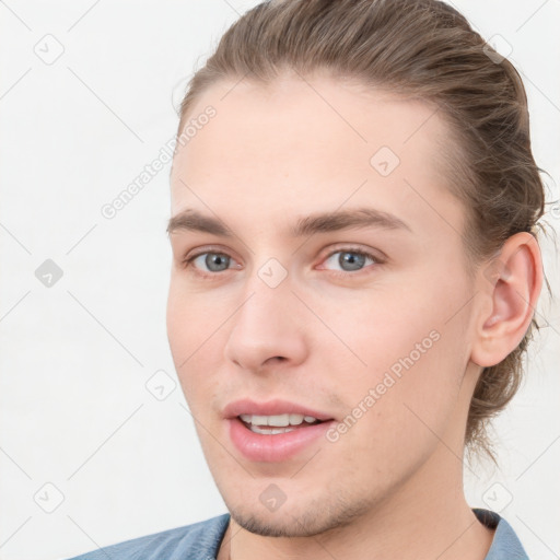 Joyful white young-adult male with short  brown hair and grey eyes