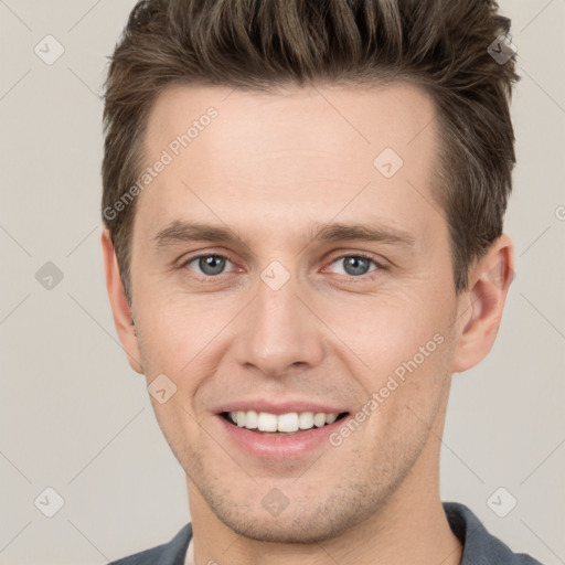 Joyful white young-adult male with short  brown hair and grey eyes