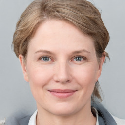 Joyful white young-adult female with medium  brown hair and blue eyes