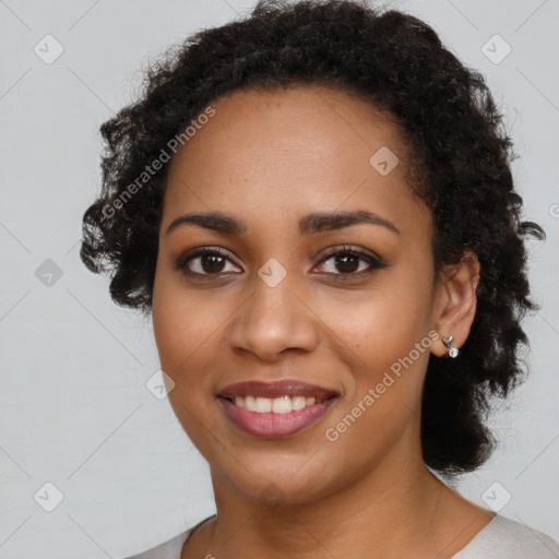 Joyful black young-adult female with long  black hair and brown eyes