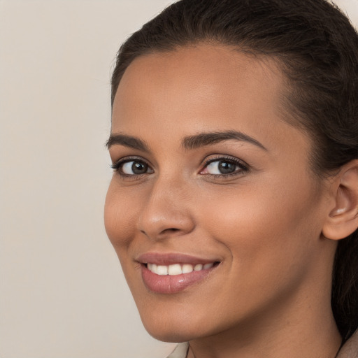 Joyful white young-adult female with long  brown hair and brown eyes