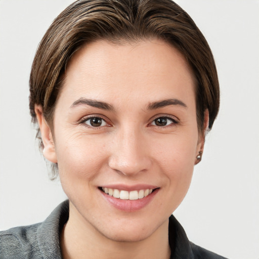 Joyful white young-adult female with short  brown hair and grey eyes