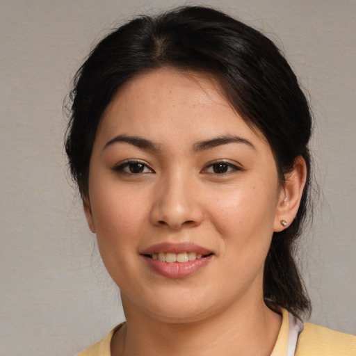 Joyful asian young-adult female with medium  brown hair and brown eyes