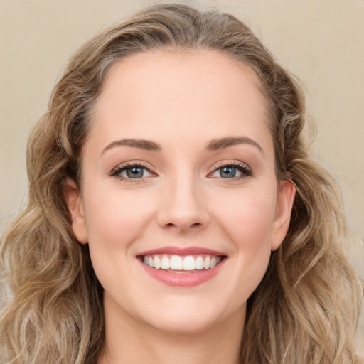 Joyful white young-adult female with long  brown hair and green eyes