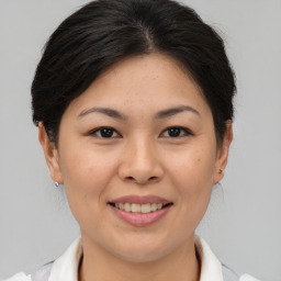 Joyful asian young-adult female with medium  brown hair and brown eyes