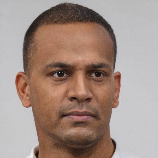 Neutral latino adult male with short  brown hair and brown eyes