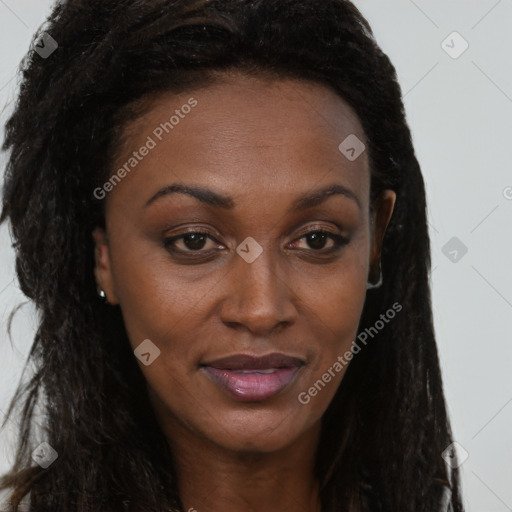 Joyful black young-adult female with long  brown hair and brown eyes