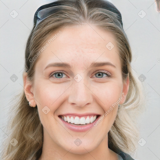 Joyful white young-adult female with long  brown hair and blue eyes