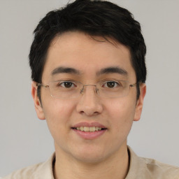 Joyful asian young-adult male with short  black hair and brown eyes