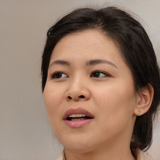 Joyful asian young-adult female with medium  brown hair and brown eyes