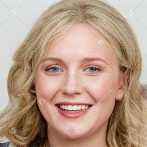 Joyful white young-adult female with long  brown hair and blue eyes