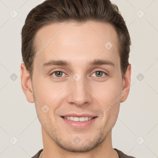 Joyful white young-adult male with short  brown hair and grey eyes