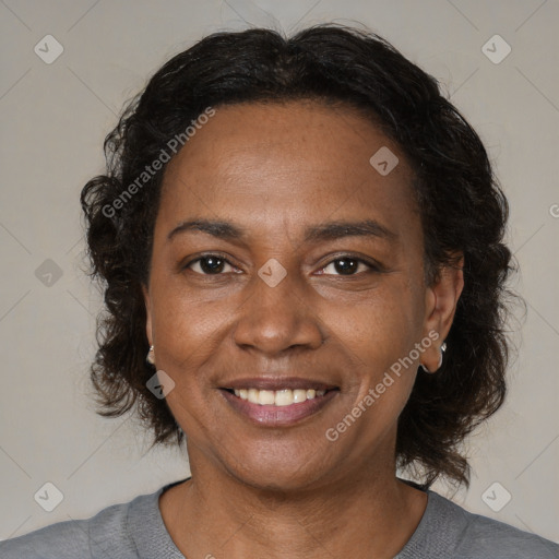 Joyful black adult female with medium  brown hair and brown eyes