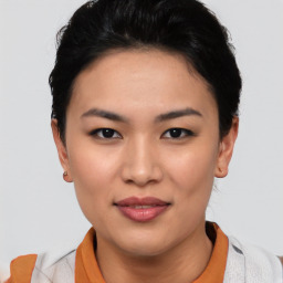 Joyful asian young-adult female with short  black hair and brown eyes