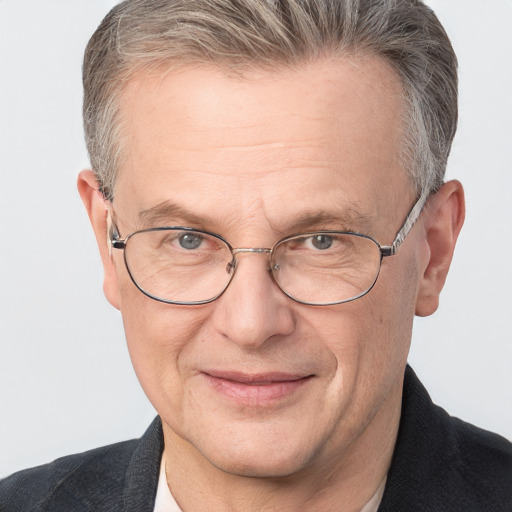 Joyful white middle-aged male with short  gray hair and blue eyes