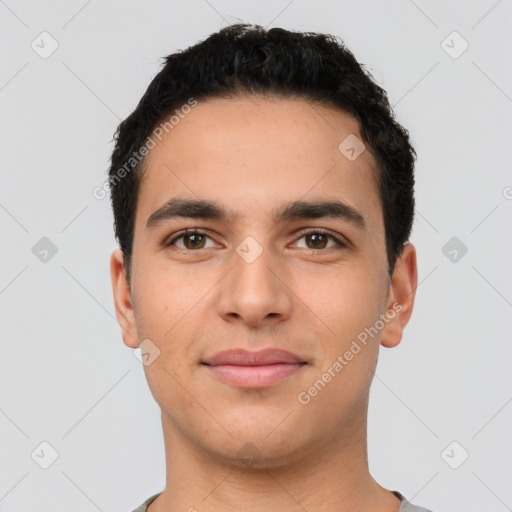 Joyful latino young-adult male with short  brown hair and brown eyes