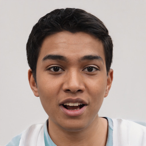 Joyful latino young-adult male with short  black hair and brown eyes