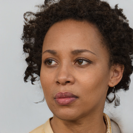 Neutral black young-adult female with medium  brown hair and brown eyes
