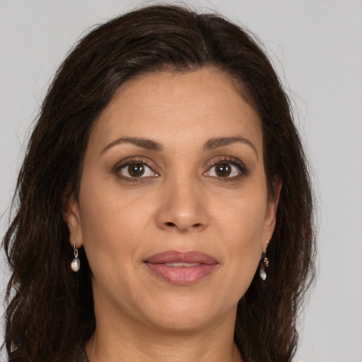 Joyful white adult female with long  brown hair and brown eyes