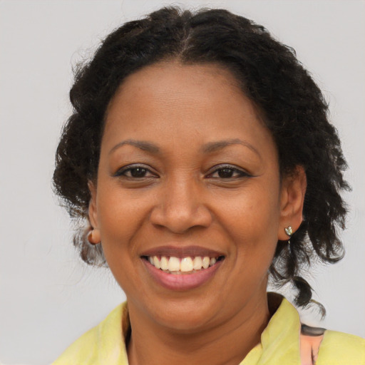 Joyful latino adult female with medium  brown hair and brown eyes