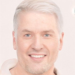 Joyful white adult male with short  blond hair and grey eyes