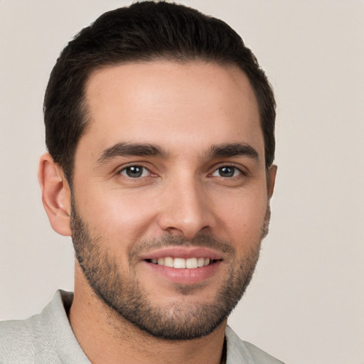 Joyful white young-adult male with short  brown hair and brown eyes