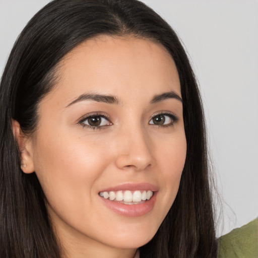 Joyful white young-adult female with long  brown hair and brown eyes